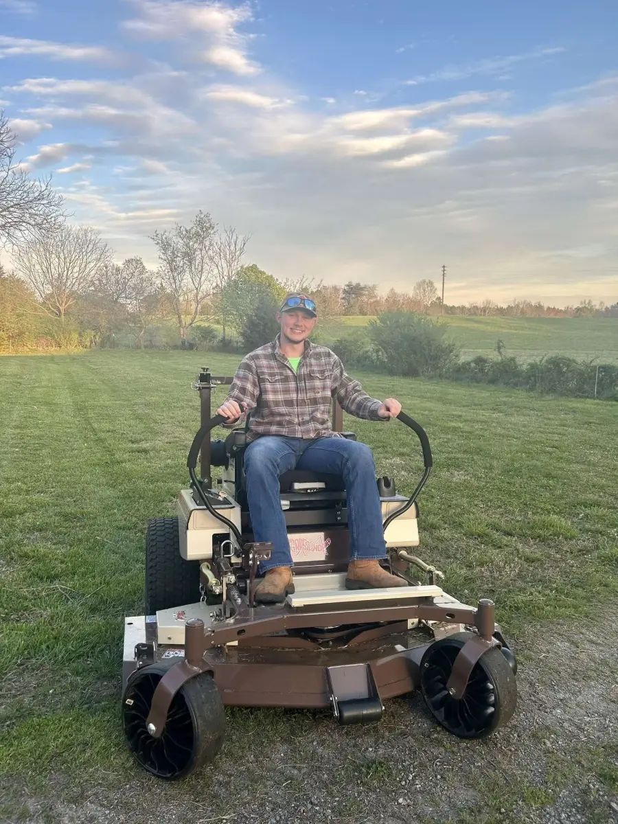 Michael Wheat sitting on a mower