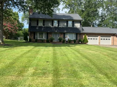 Striped lawn in front of a house with a three-car garage