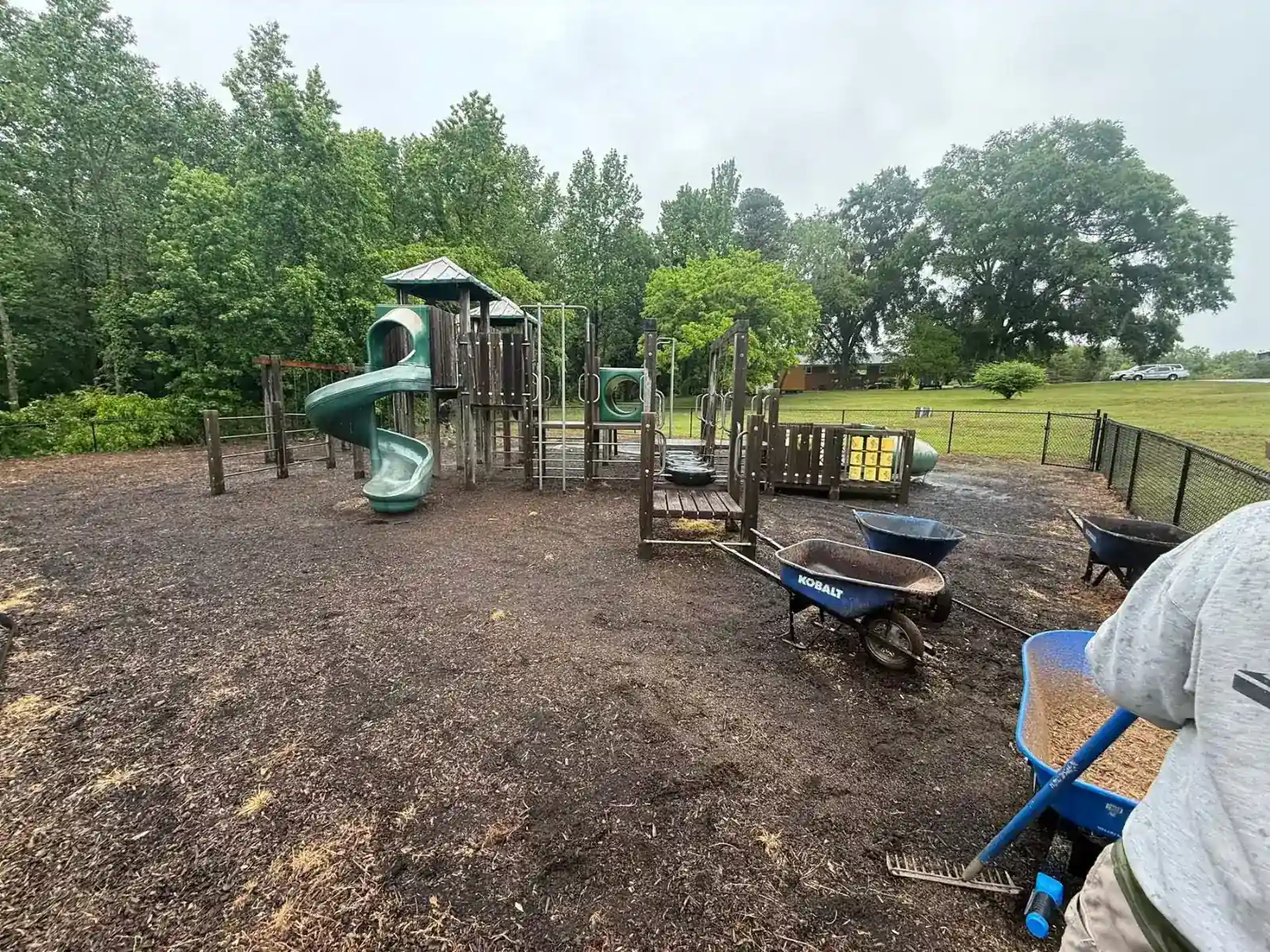 Playground with worn ground covering before mulch replacement