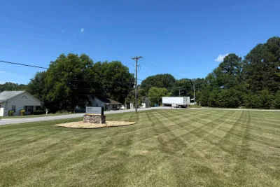 Mowed commercial lot with a sign
